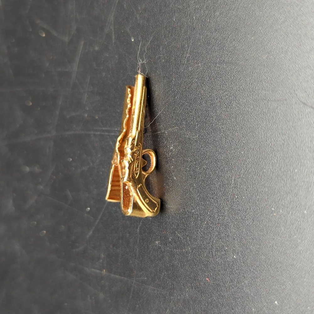 Gold tone revolver gun tie tack